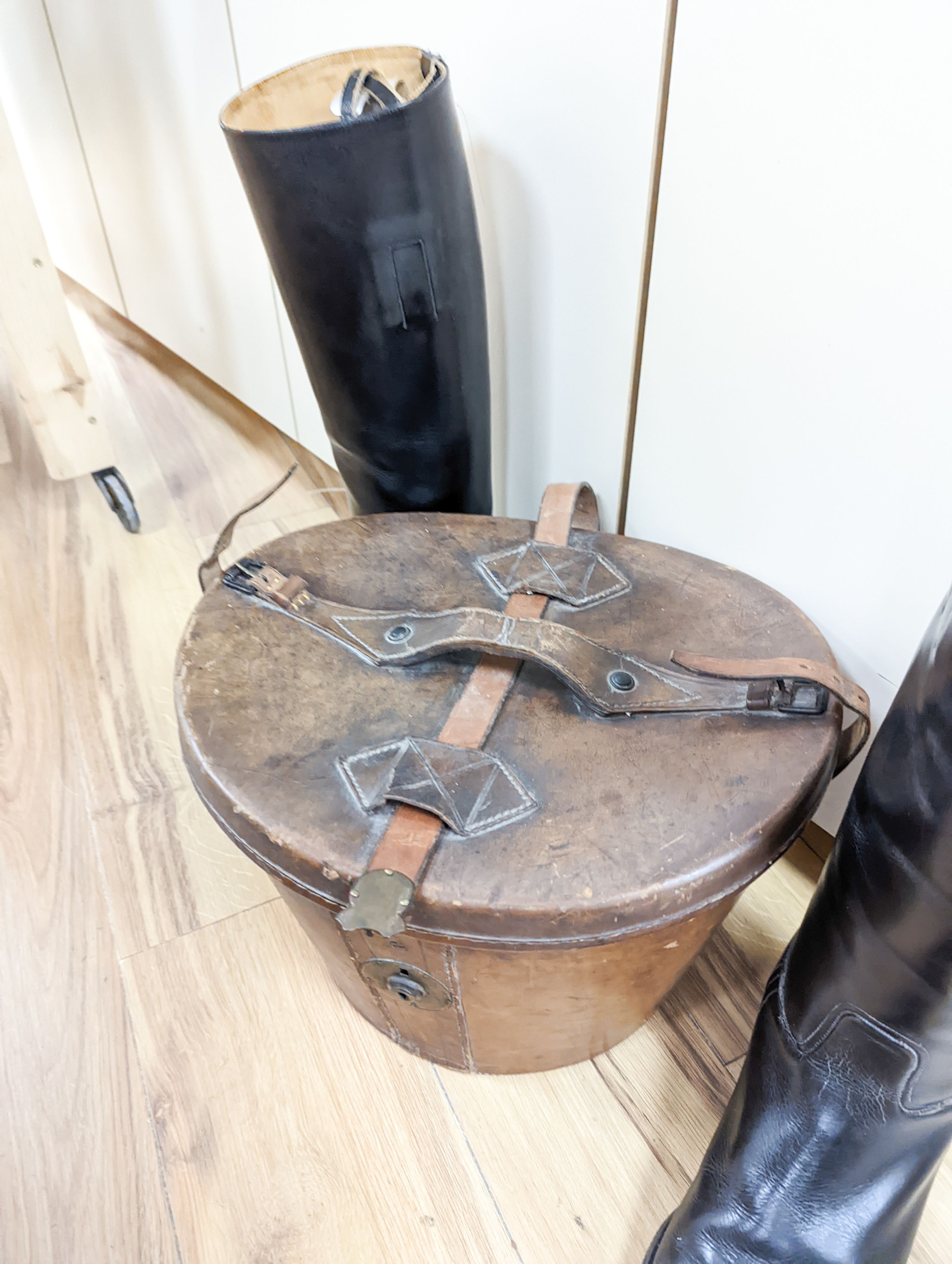 A gents 8 1/2 sized riding boots and a brown leather case for a top hat